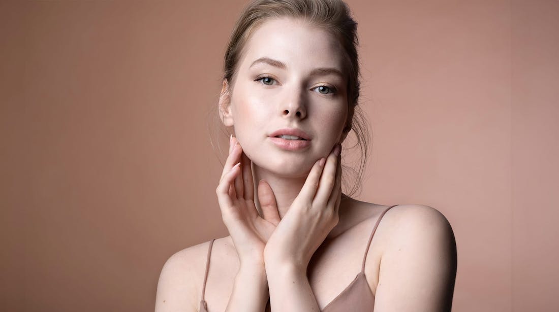 woman touching sides of face