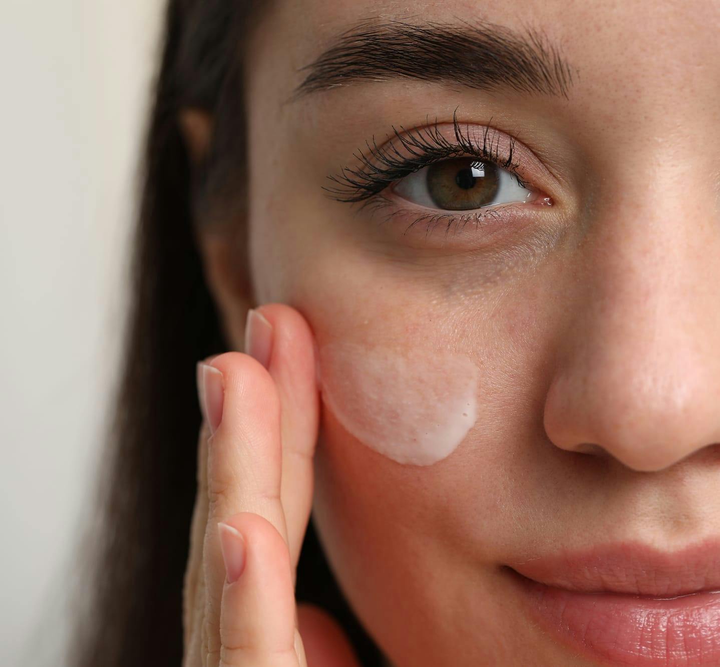 woman applying facial cream