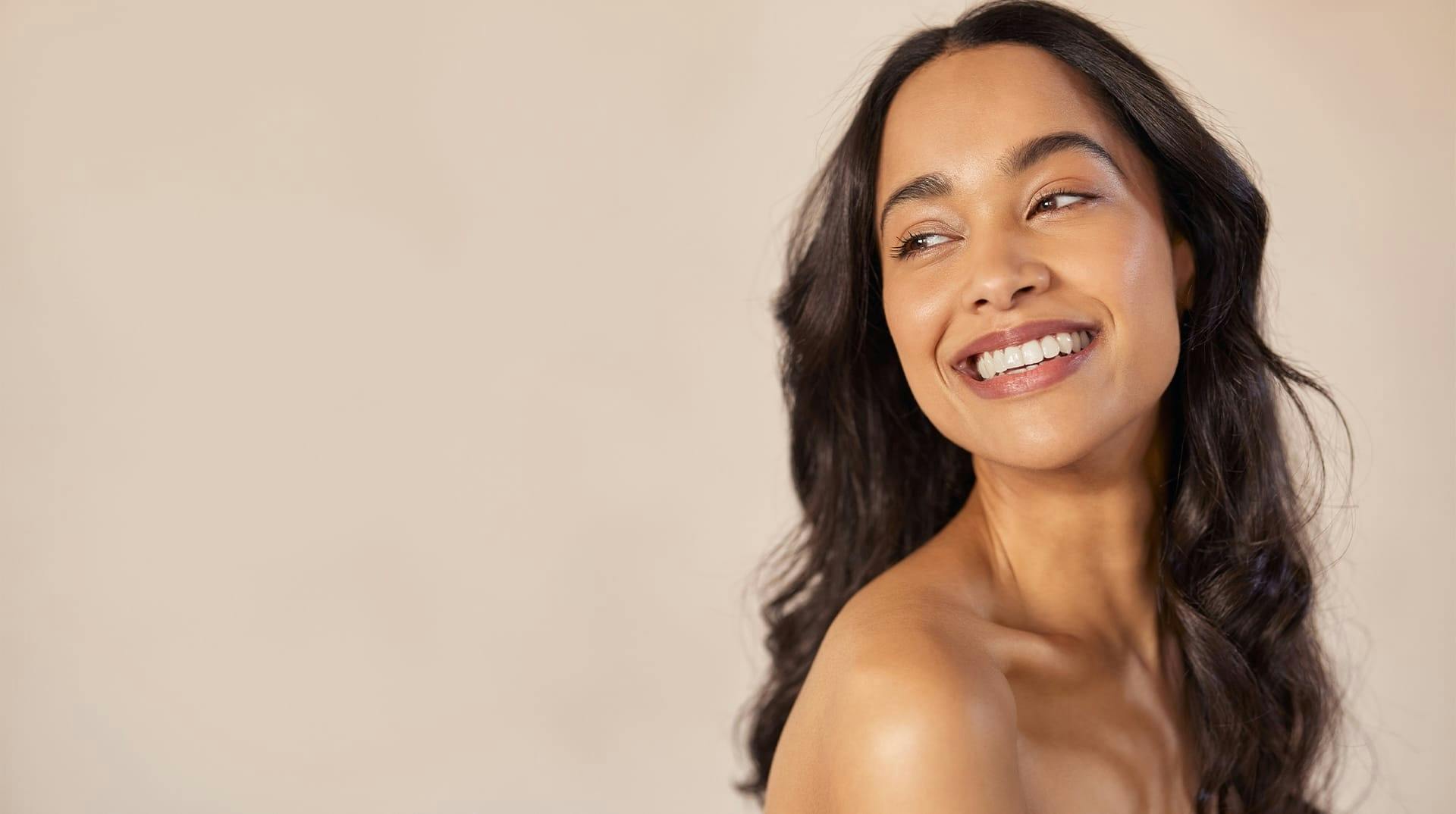 woman looking over shoulder smiling