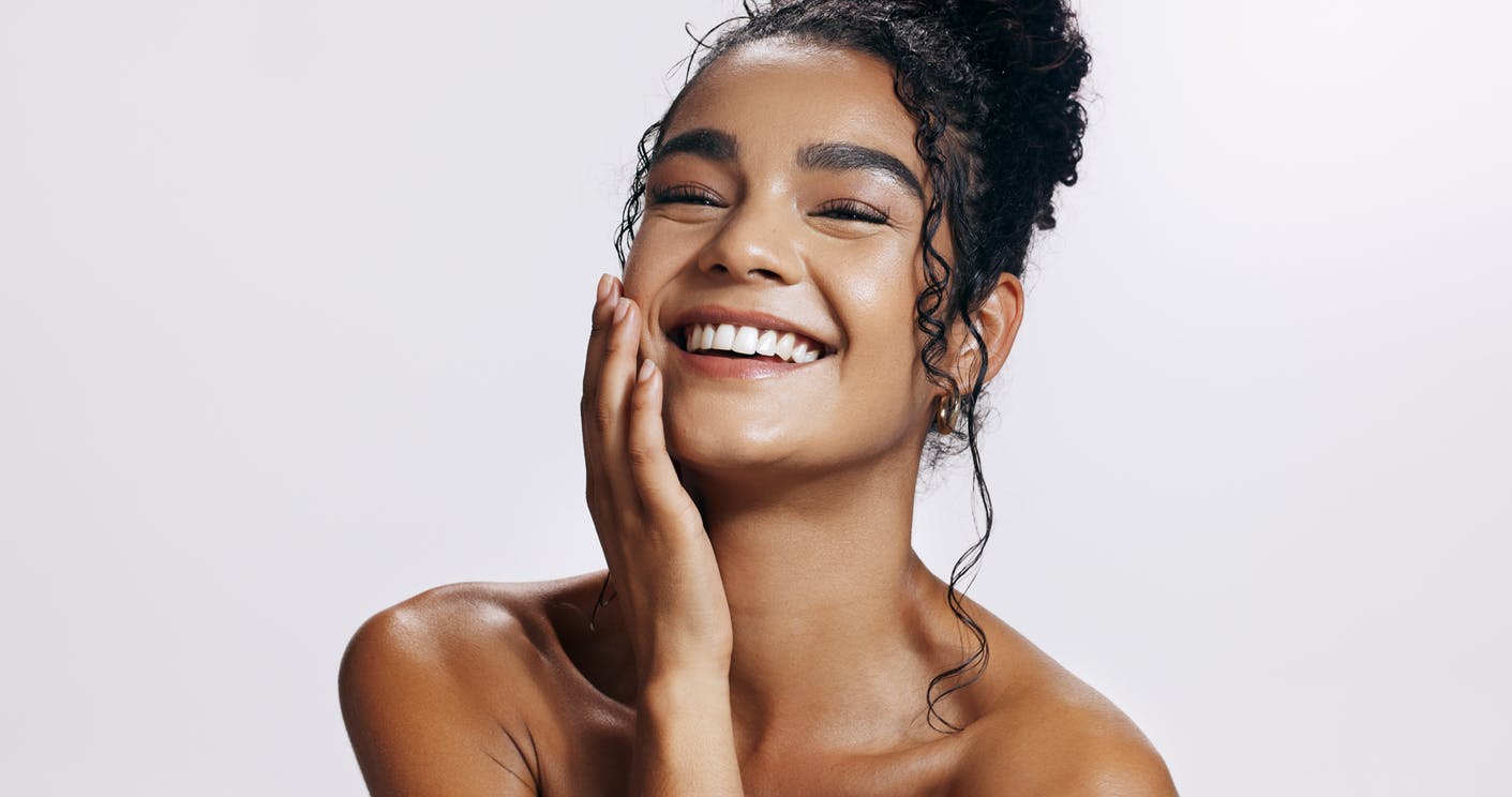 Woman touching her face and smiling