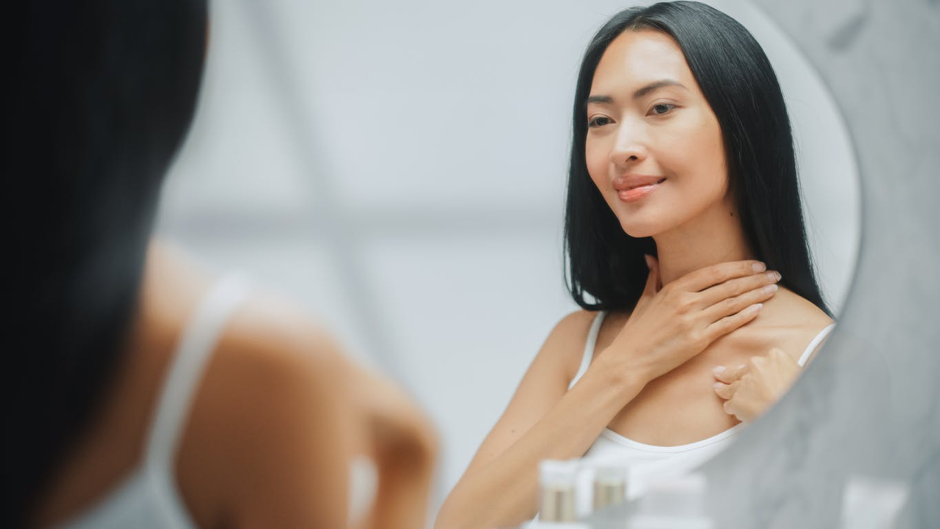 Woman touching her neck