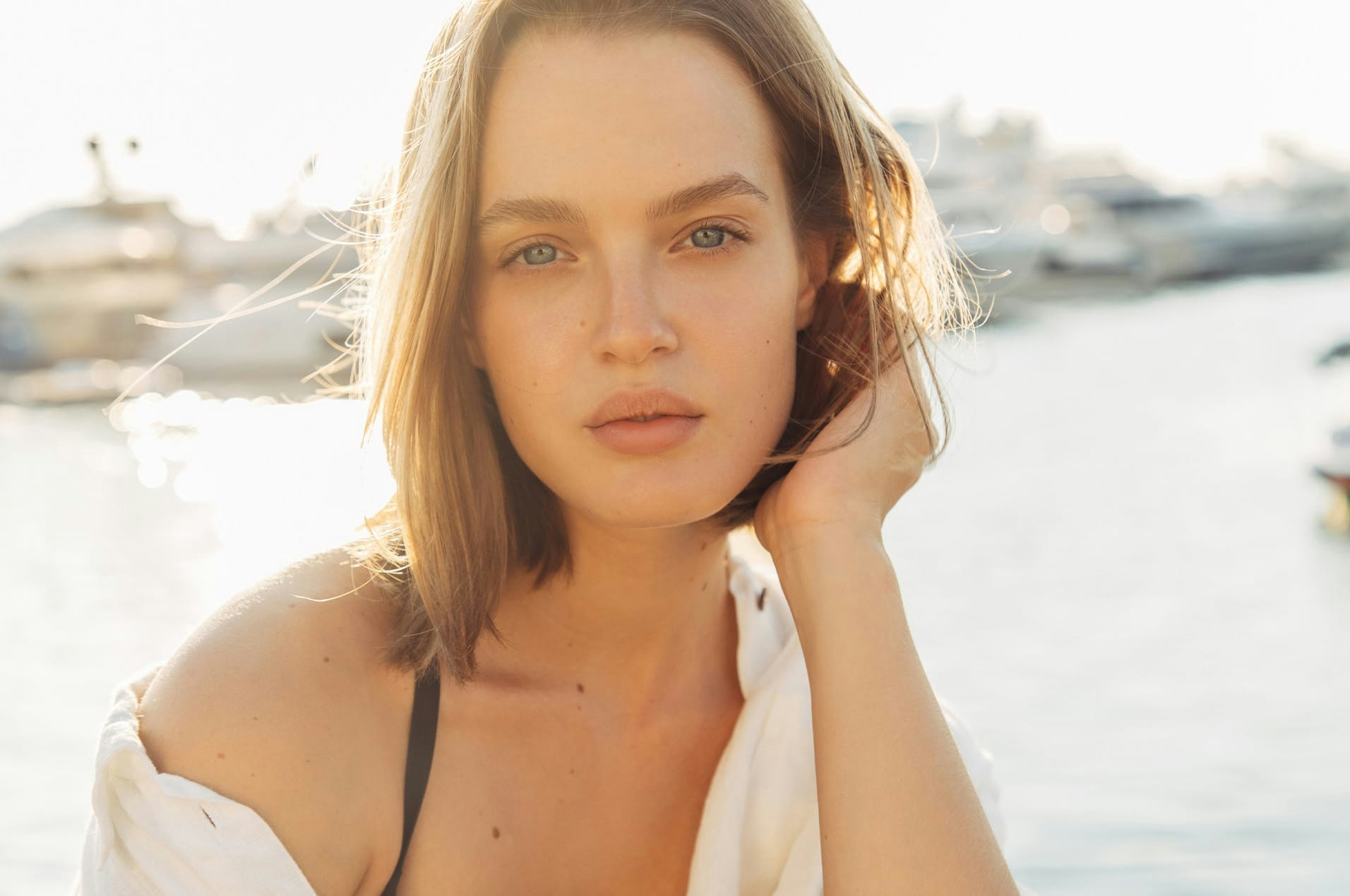 Woman by water looking at camera