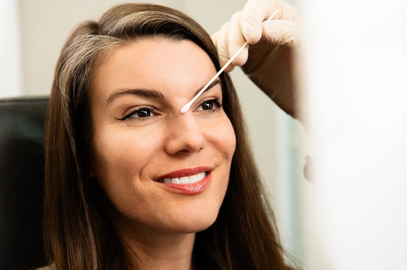 woman with a q-tip on her nose