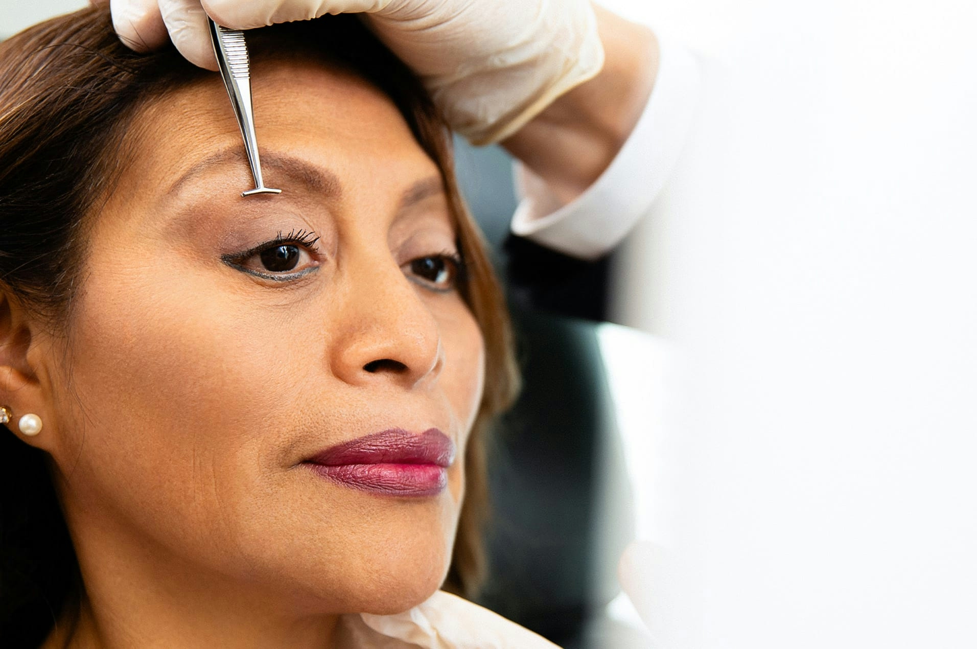 Woman receiving eyelid exam