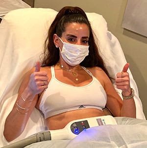 patient giving thumbs up before CoolSculpting