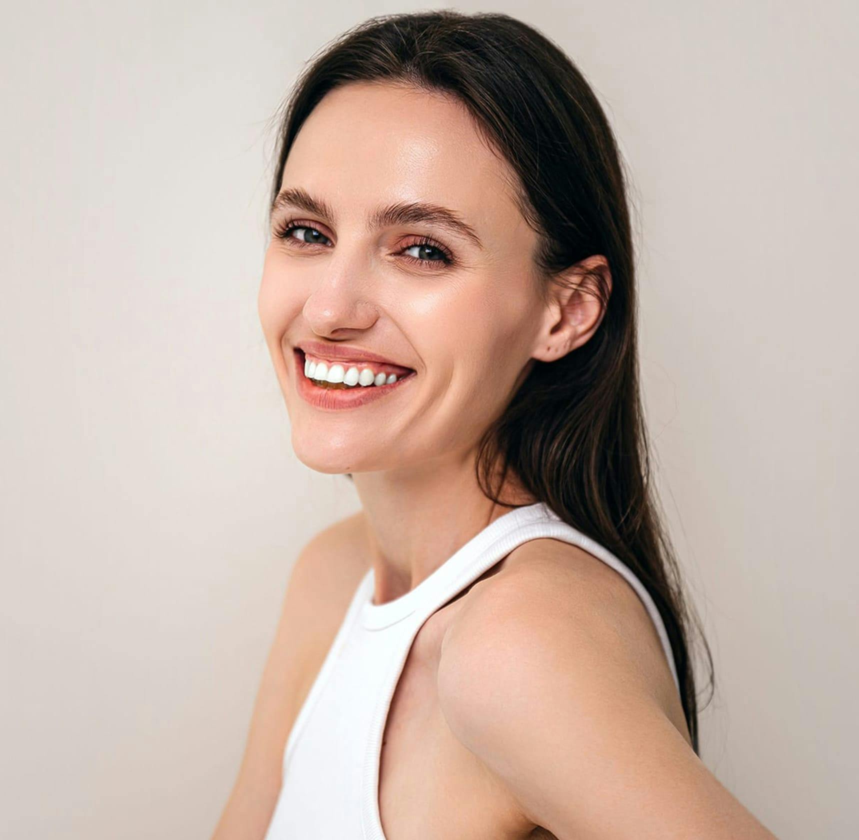 Woman laughing and looking at camera