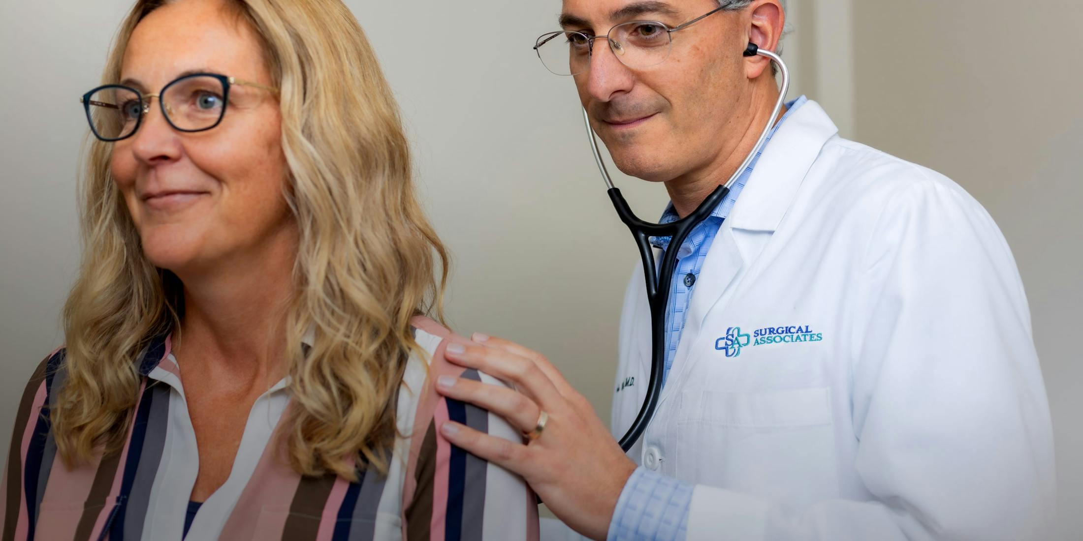 Doctor using a stethoscope on a patient