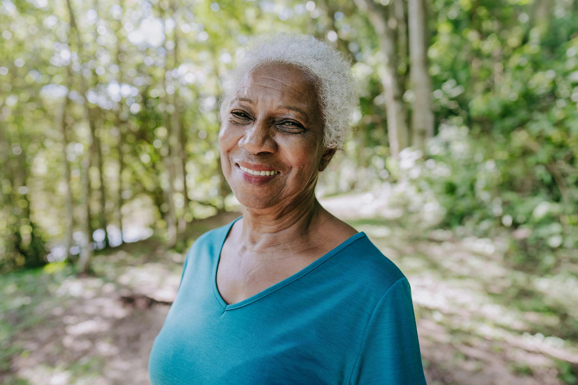 smiling woman amongst the trees