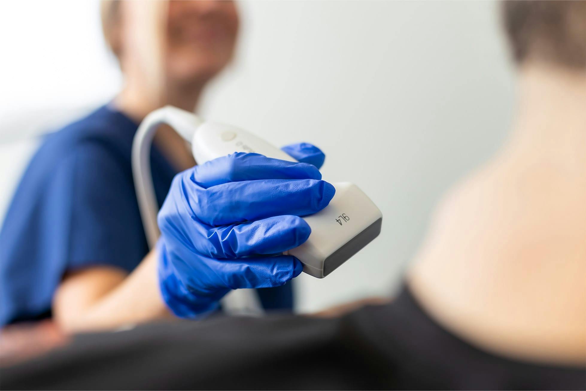 nurse using ultrasound with patient