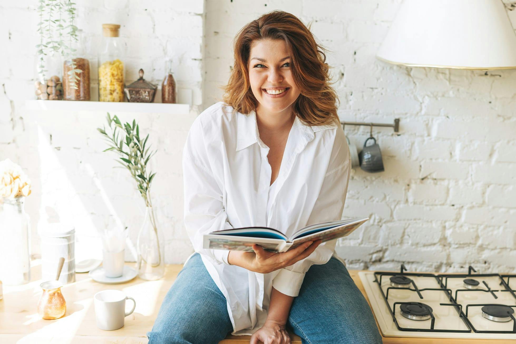woman sitting on kitchen counter