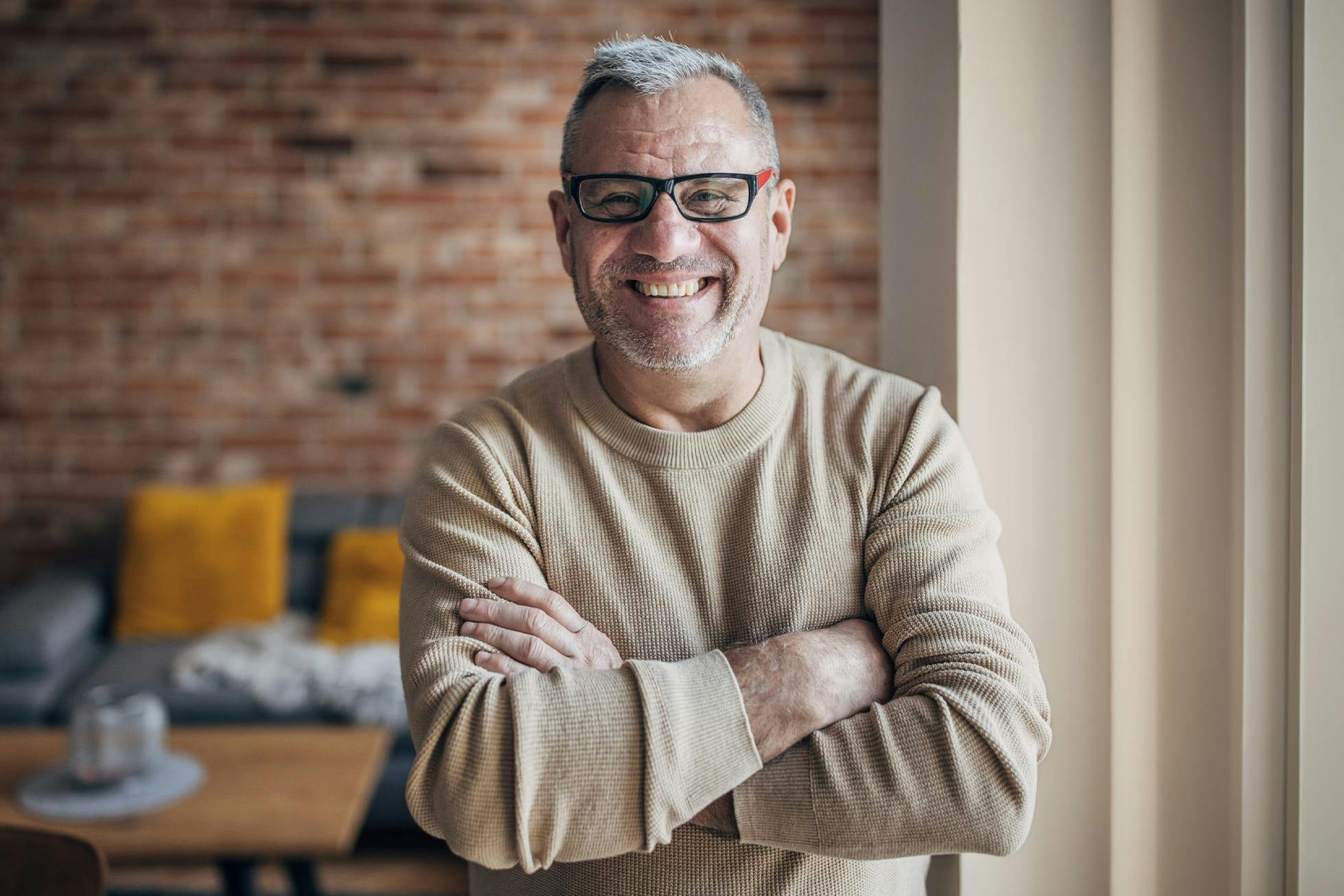 smiling man with his arms crossed