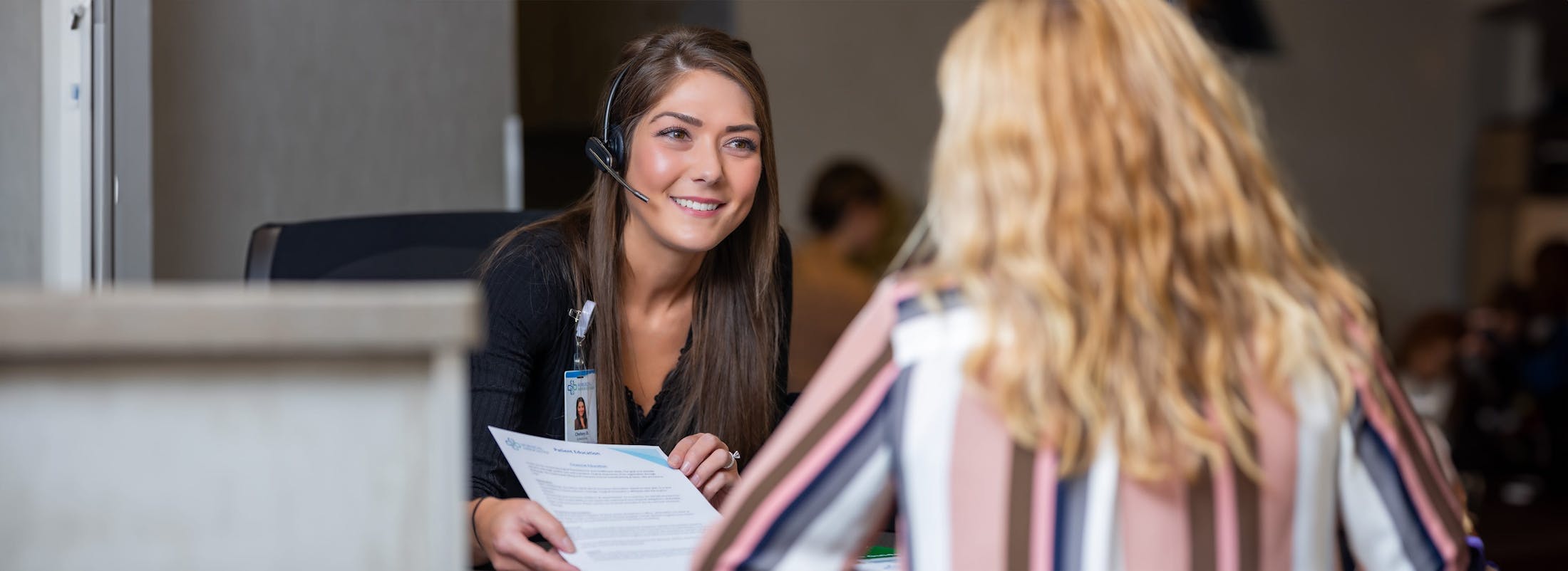 front desk consulting with patient