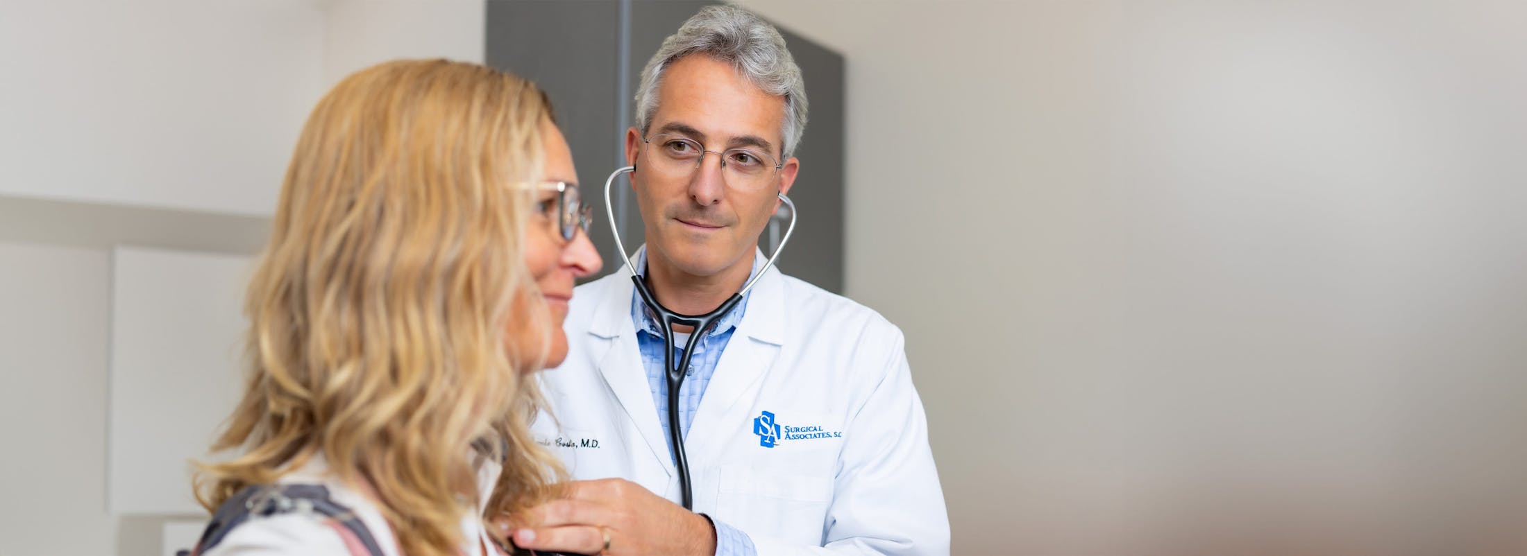 doctor checking patient with a stethoscope