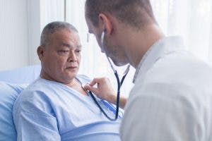 Doctor checking patient heart beat