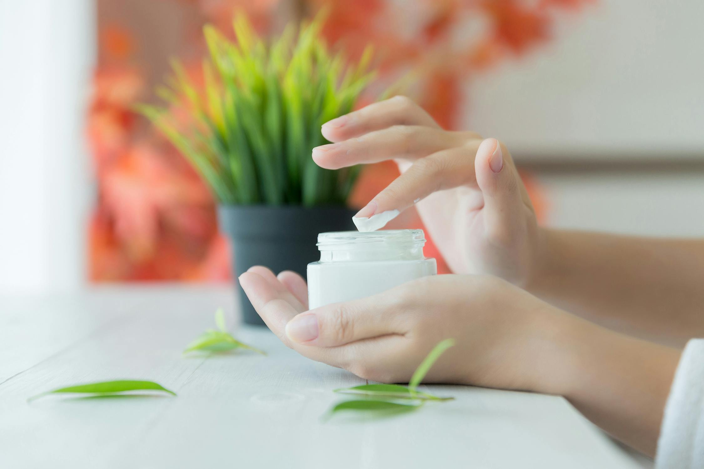 Woman with skin cream in hands