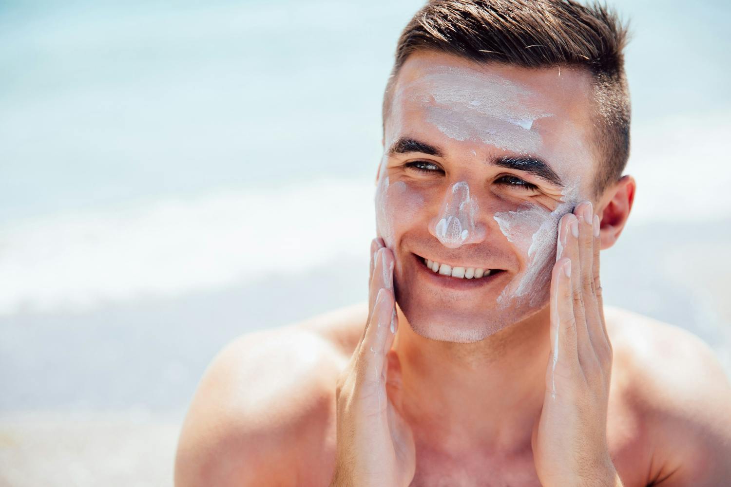 Man putting on sun screen