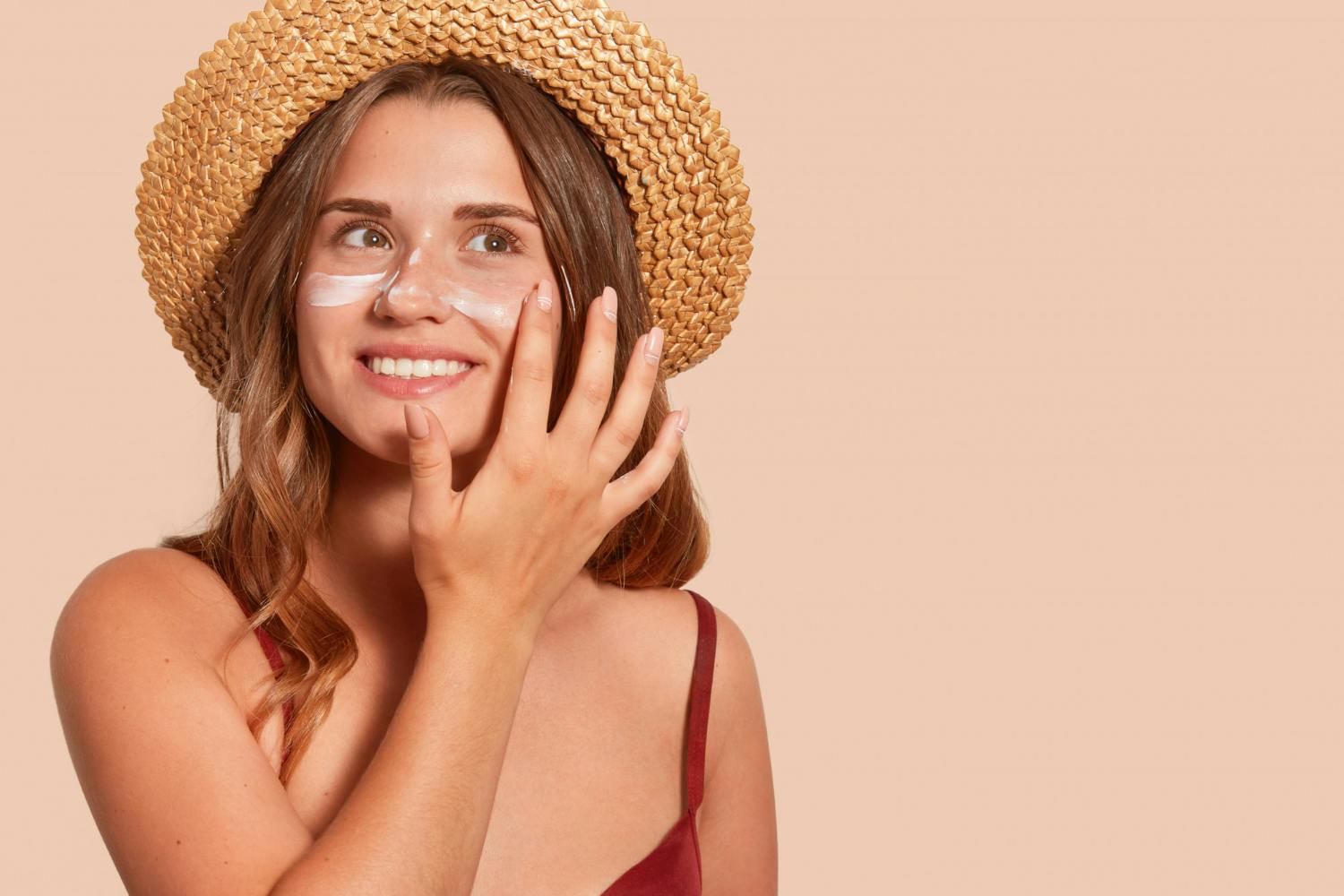 Woman putting on sunscreen