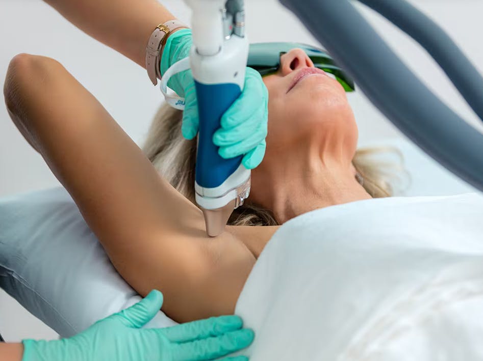 Woman receiving laser hair removal on armpit