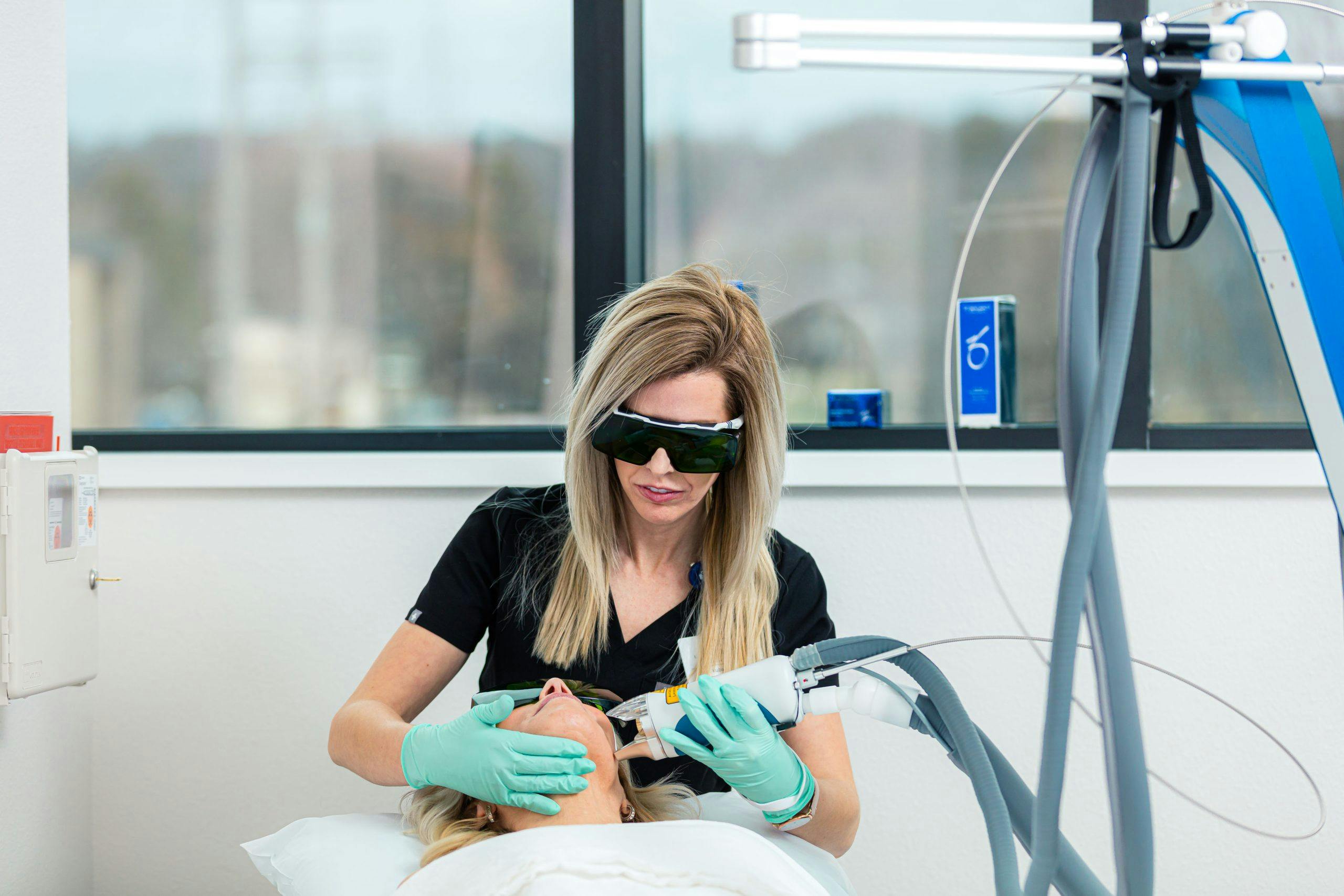 Woman receiving laser hair removal on face