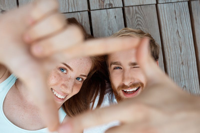 Couple making square with fingers