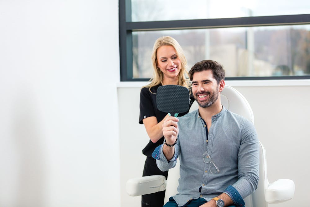 male patient smiling at mirror