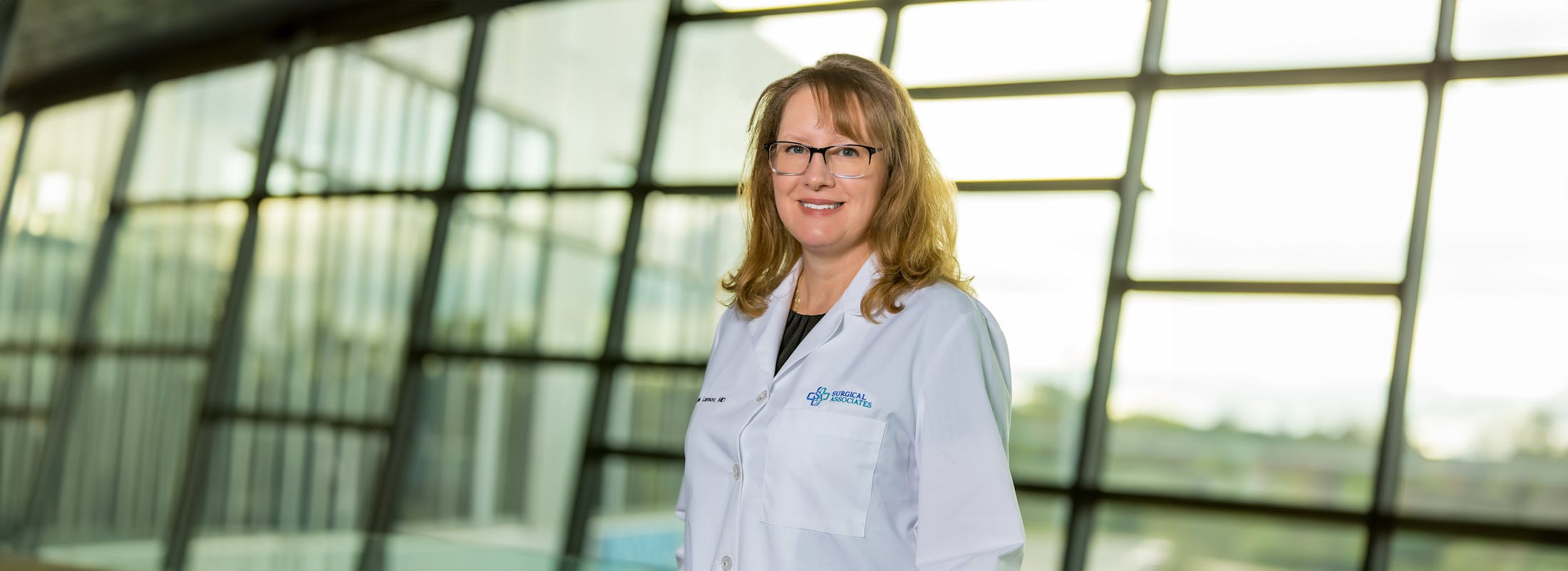 doctor leaning on glass railing