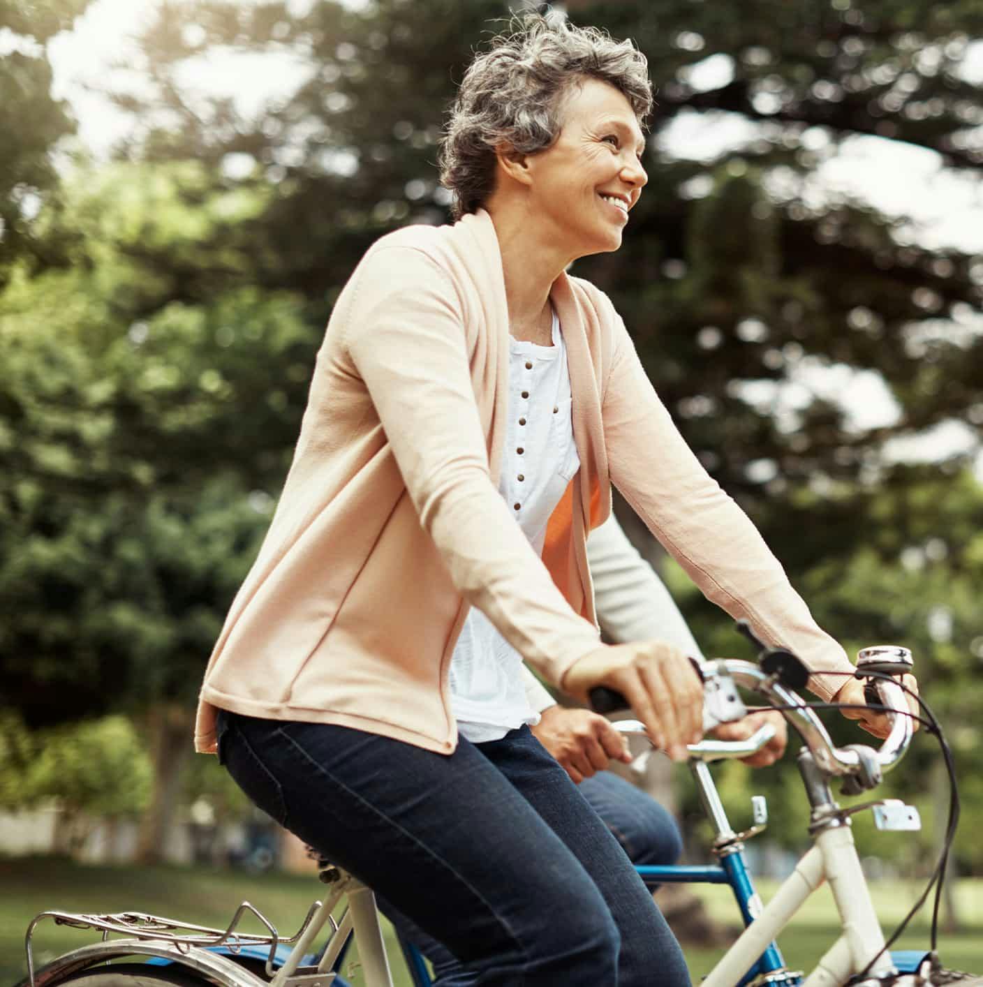 Woman smiling while riding bike