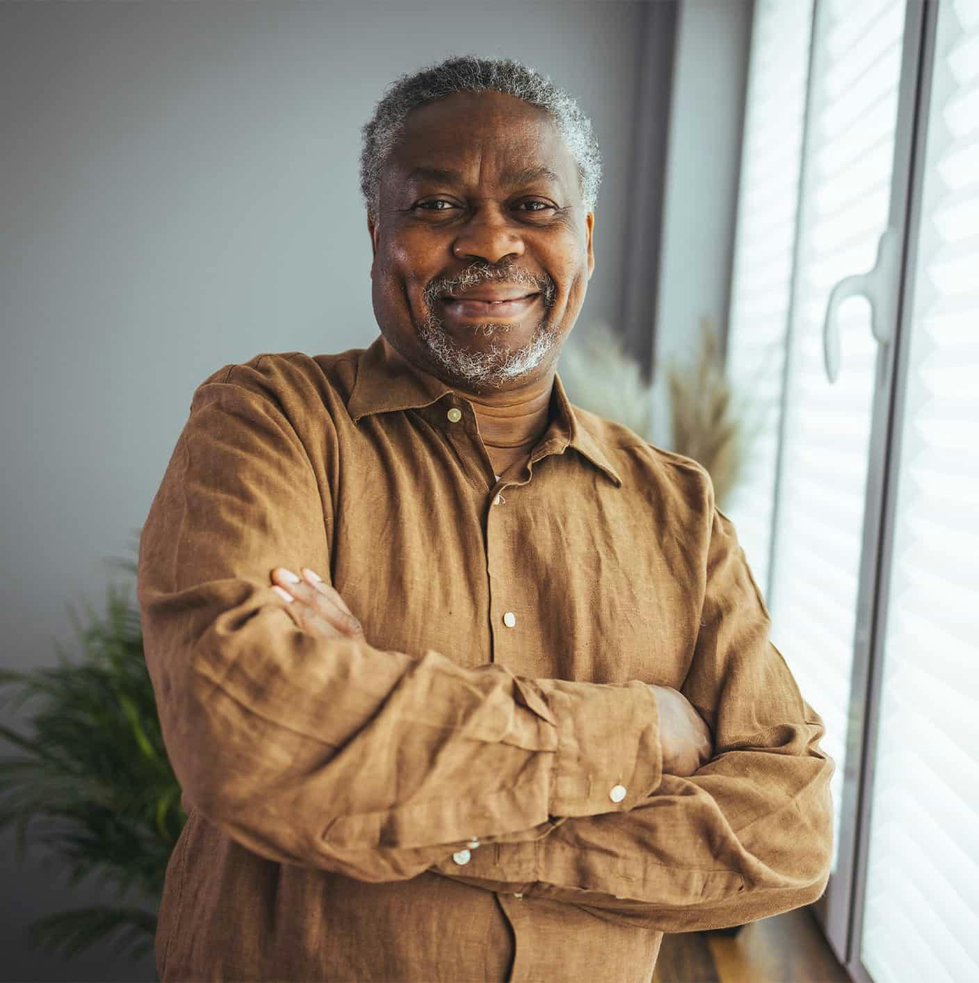 Older man smiling near window