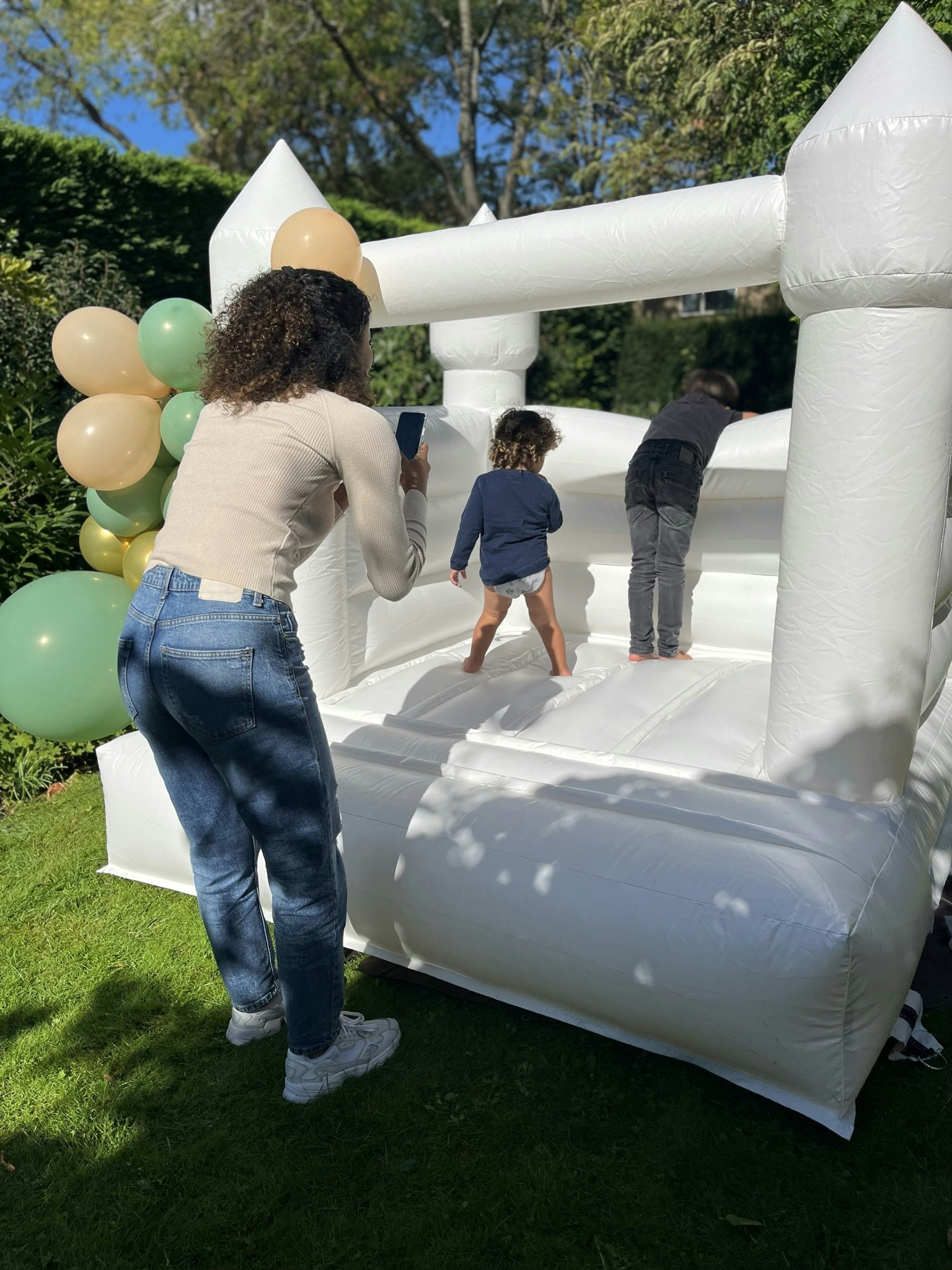 Aye, owner of Hopi Paradise, photographing a soft play bouncy castle with children