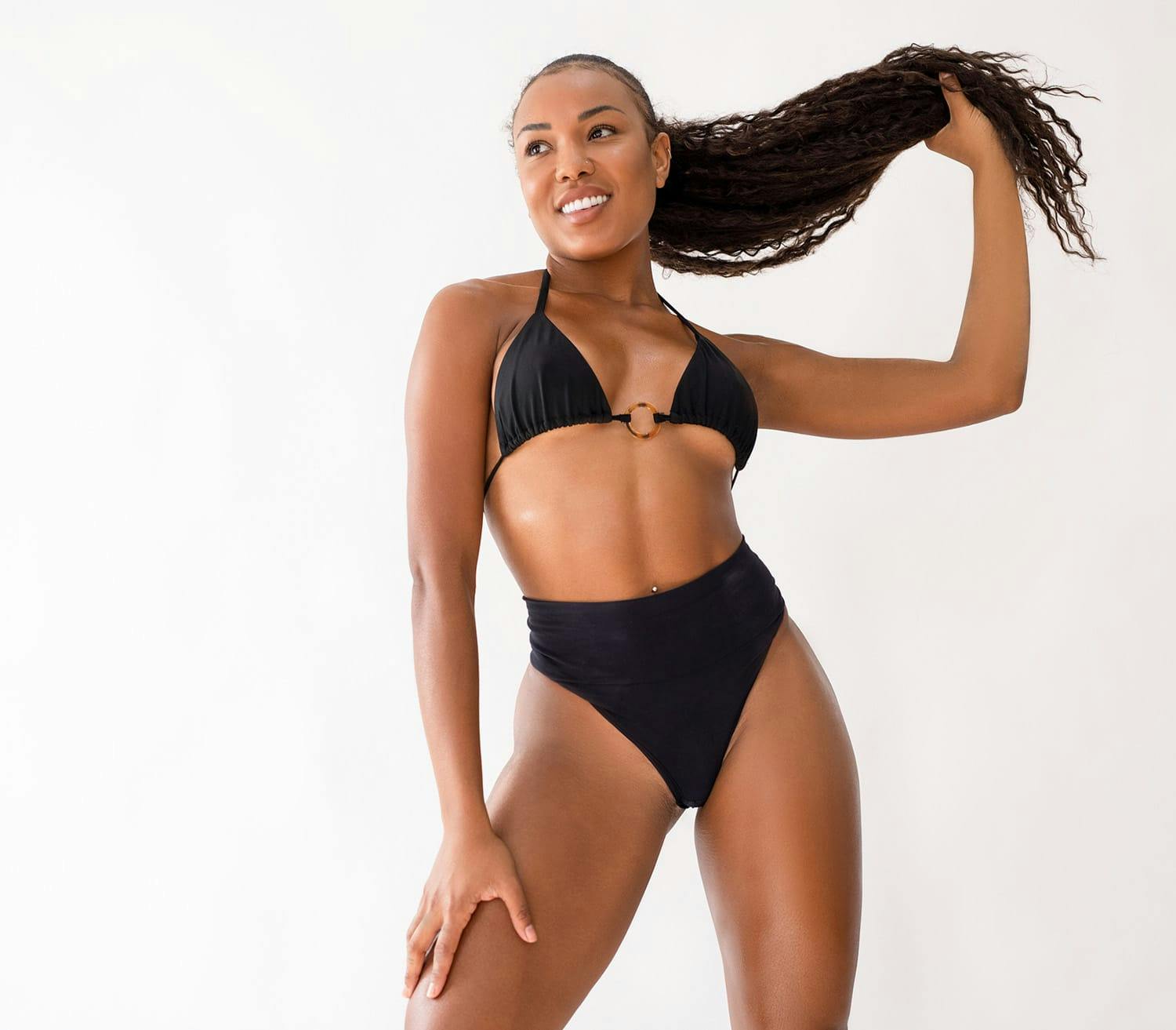 woman in black bikini holding up her hair