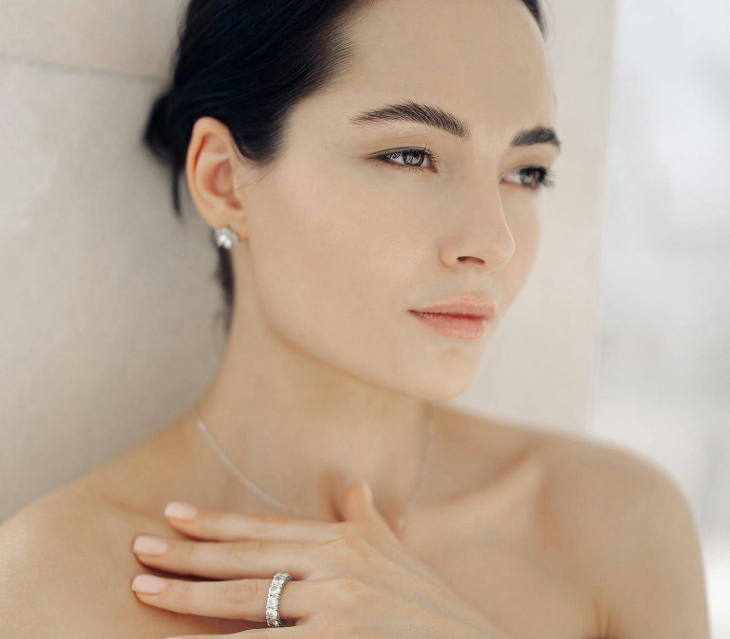 woman touching her collarbone