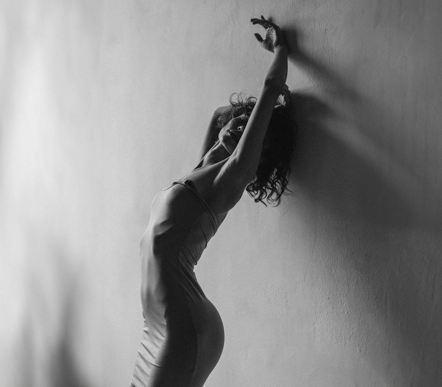 woman leaning against a wall