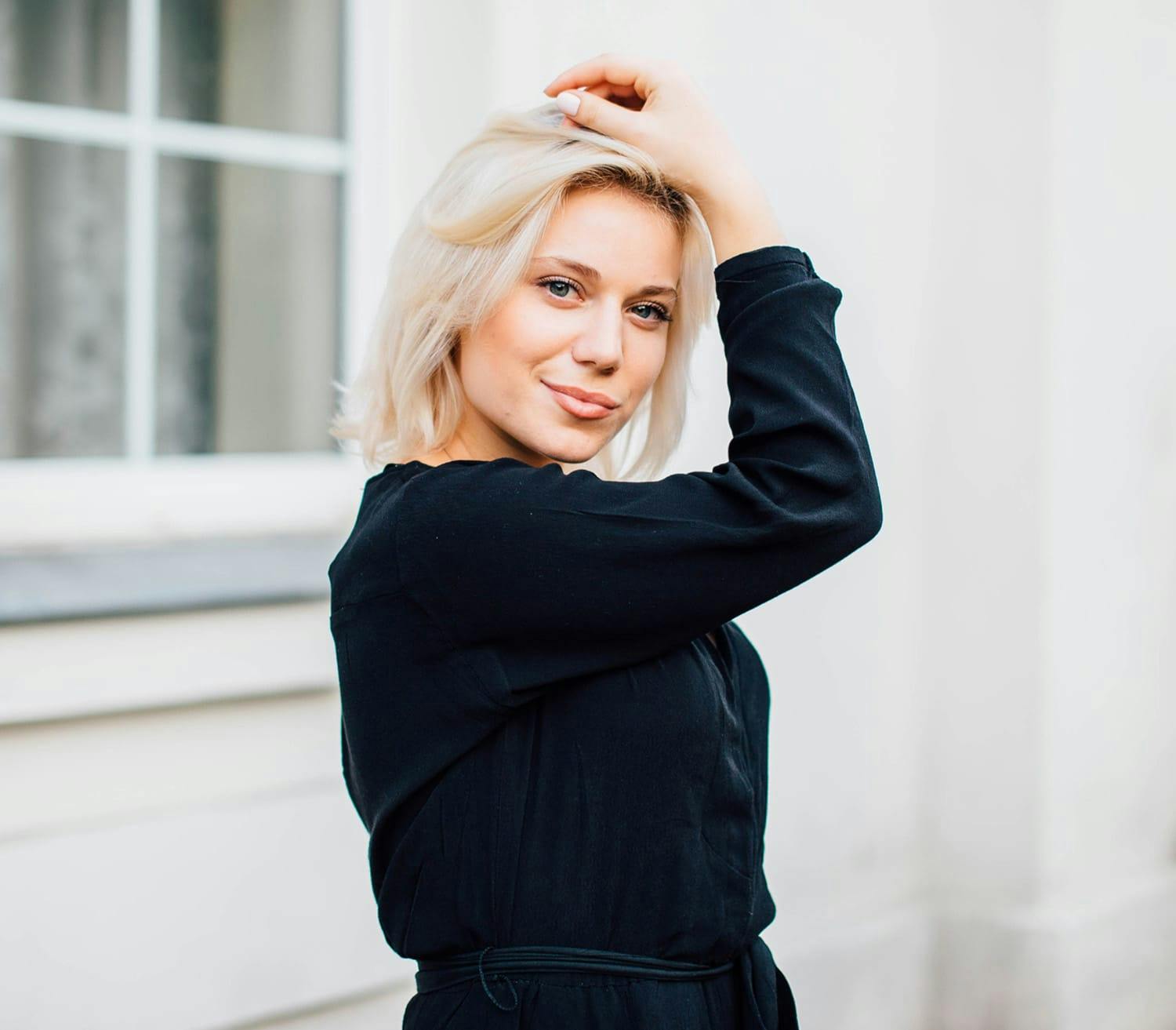 woman holding her hand on her head