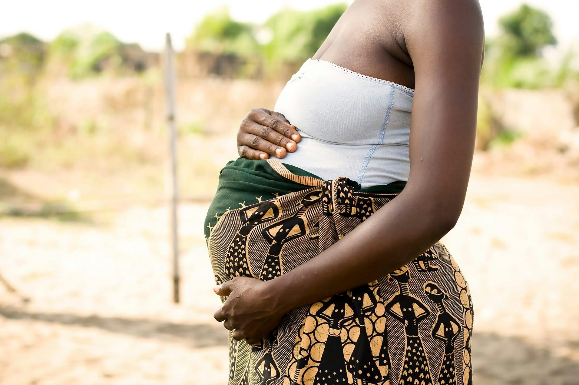 side angle of woman's pregnant belly