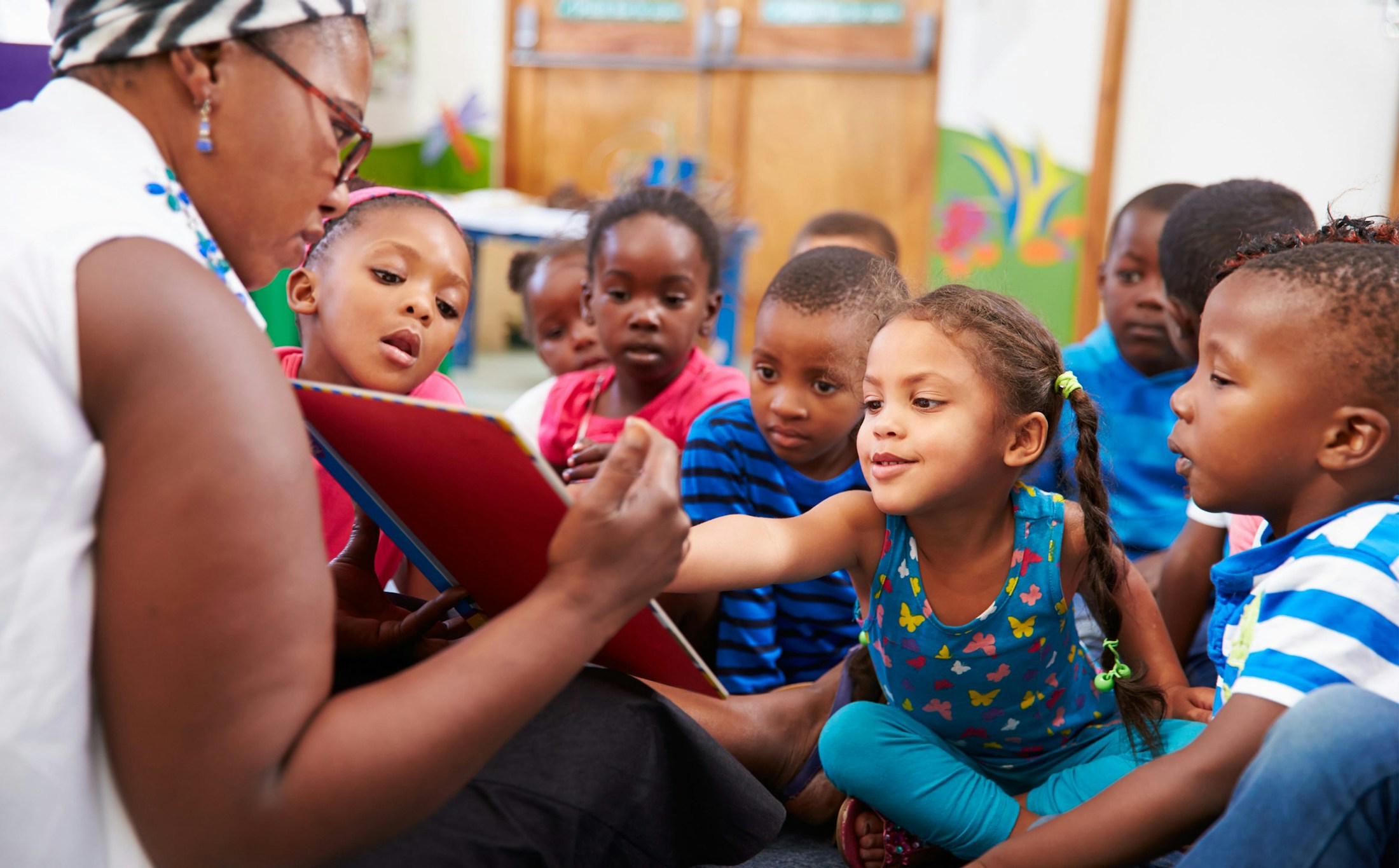 group of kids looking at teacher's board