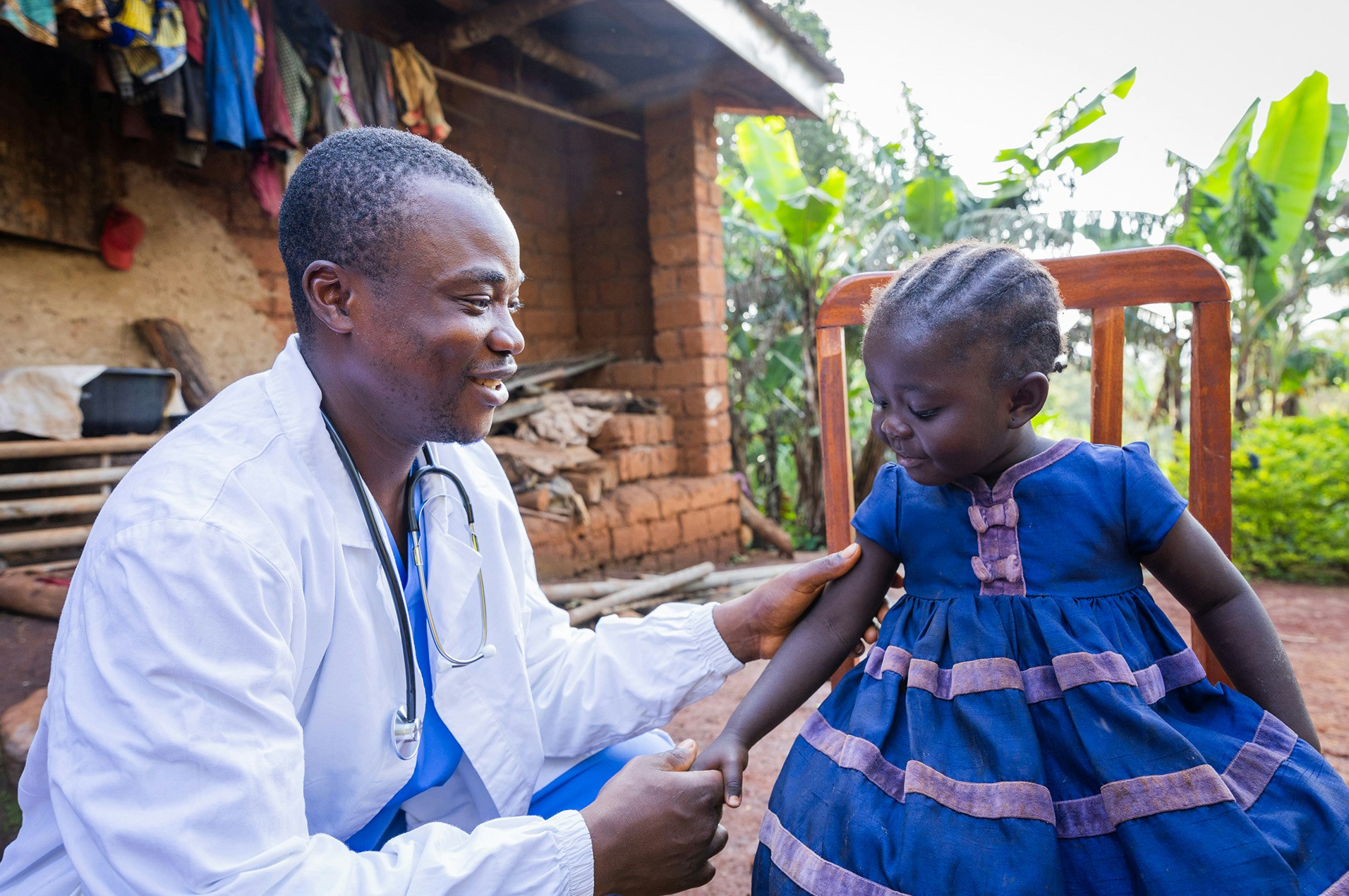 doctor checking little girl's arm