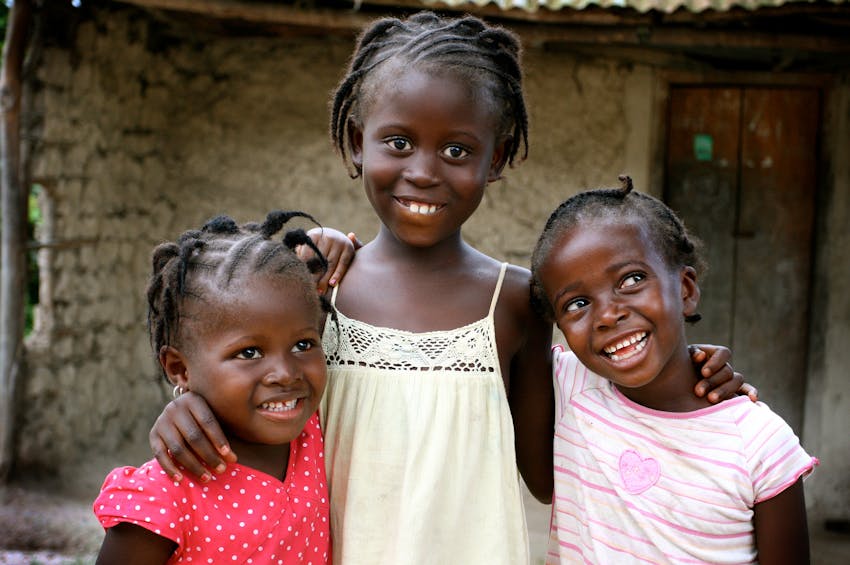 3 girls smiling and hugging