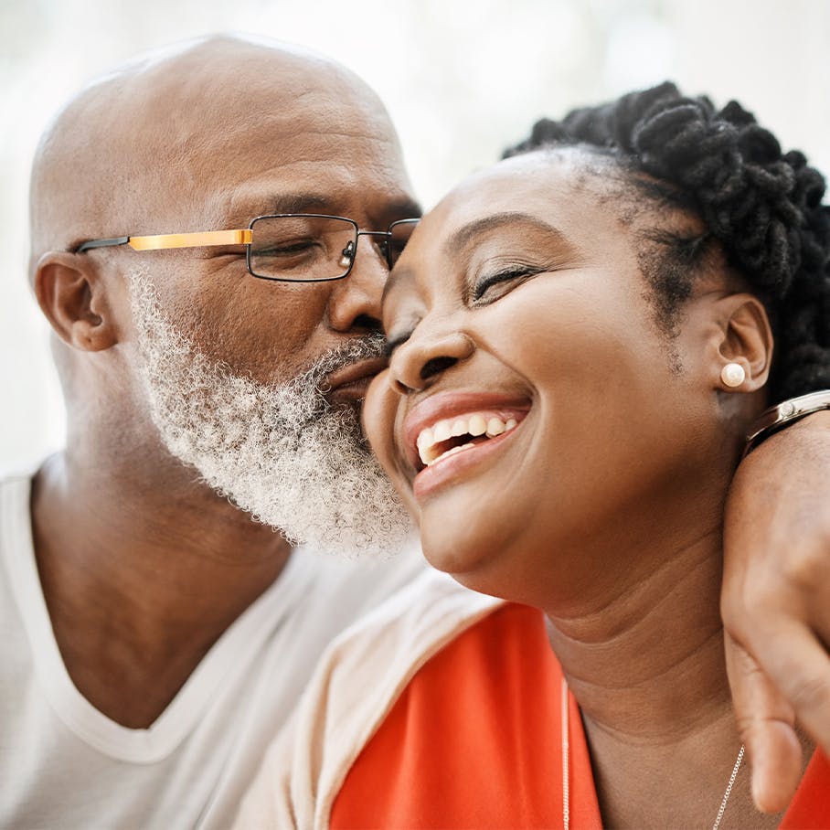 Man kissing his wife on the cheek after testosterone replacement therapy in Colts Neck, NJ