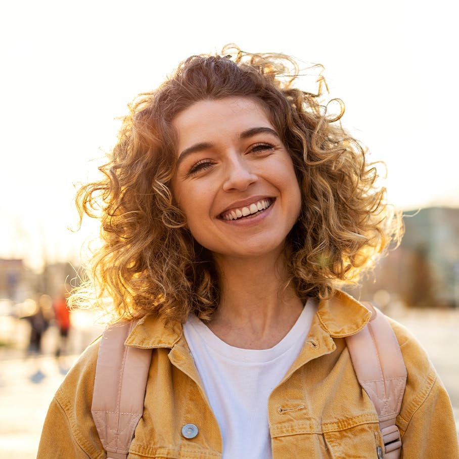 Woman with curly hair smiling