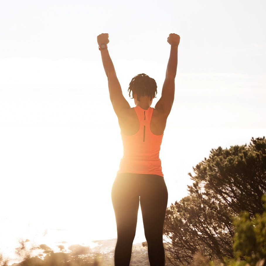 Woman standing outside with her arms up