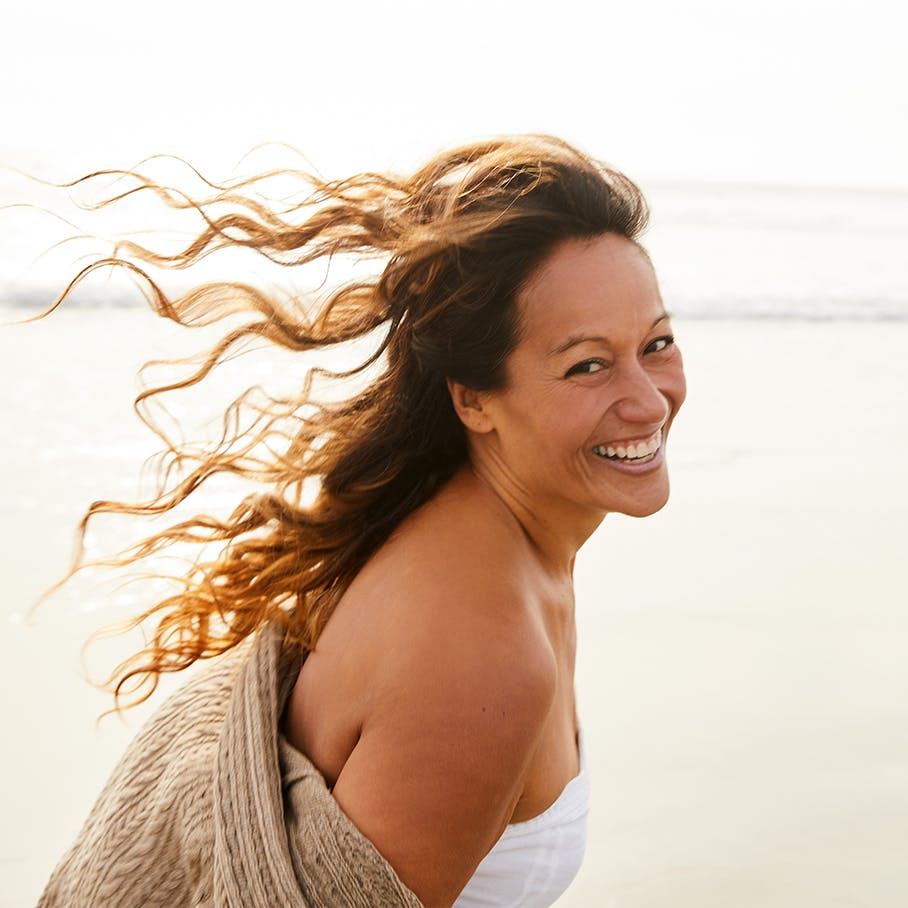 Woman smiling at the beach