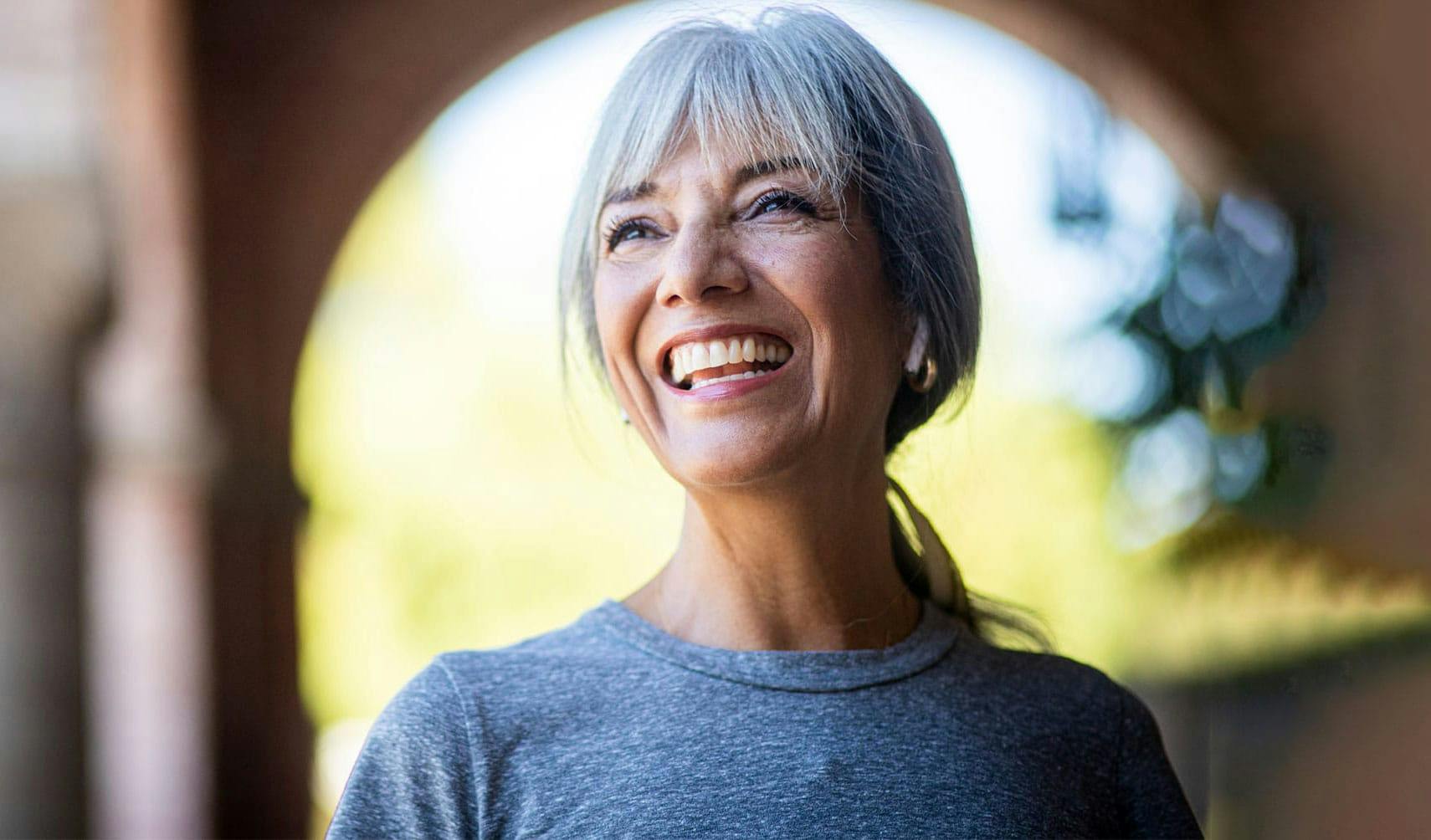 Woman smiling after hormone replacement therapy in Doc Phillips