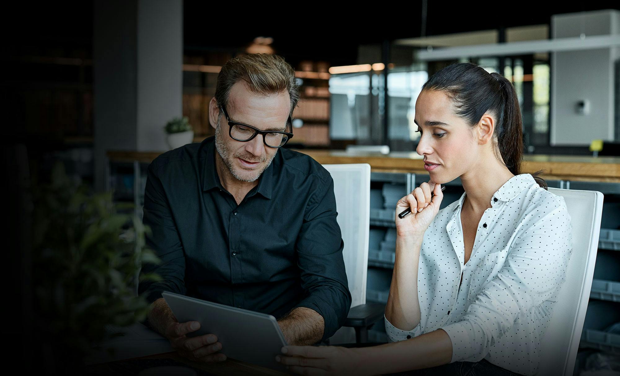 Man and woman looking at tablet