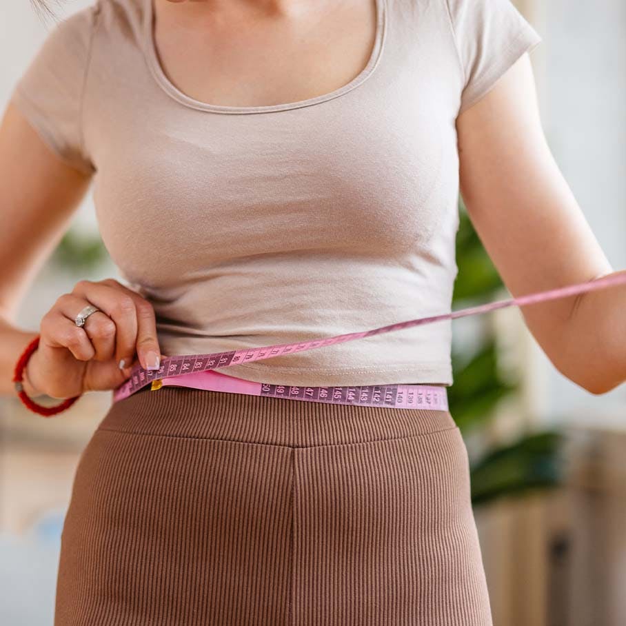 woman measuring waist after weight loss in Cherry Hill, NJ