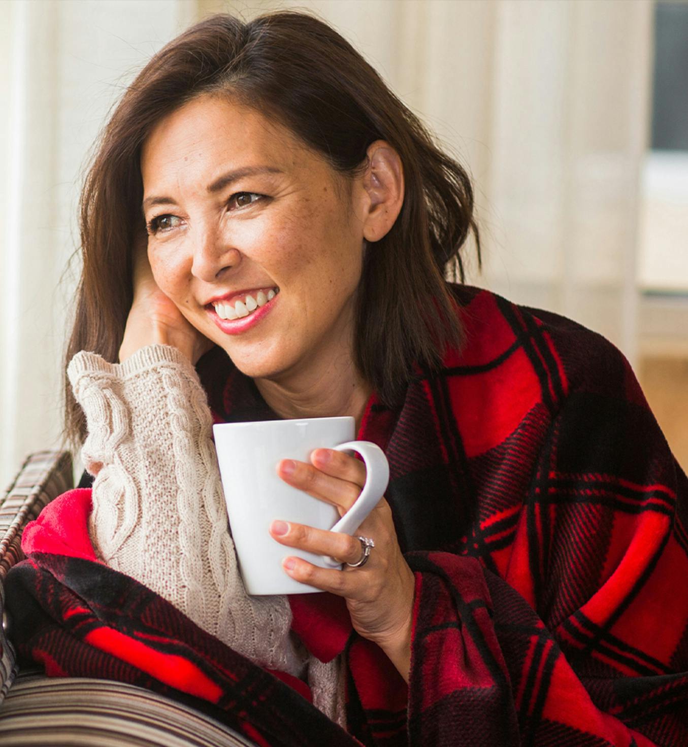 Woman with a blanket sitting down