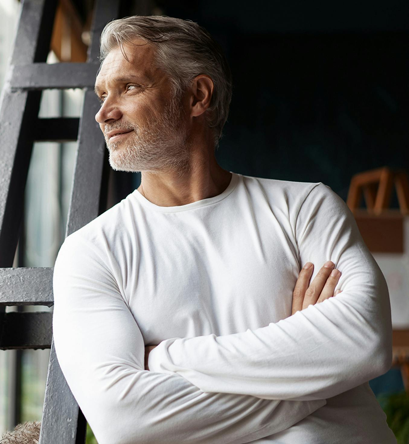 Man wearing a white t-shirt and crossing his arms