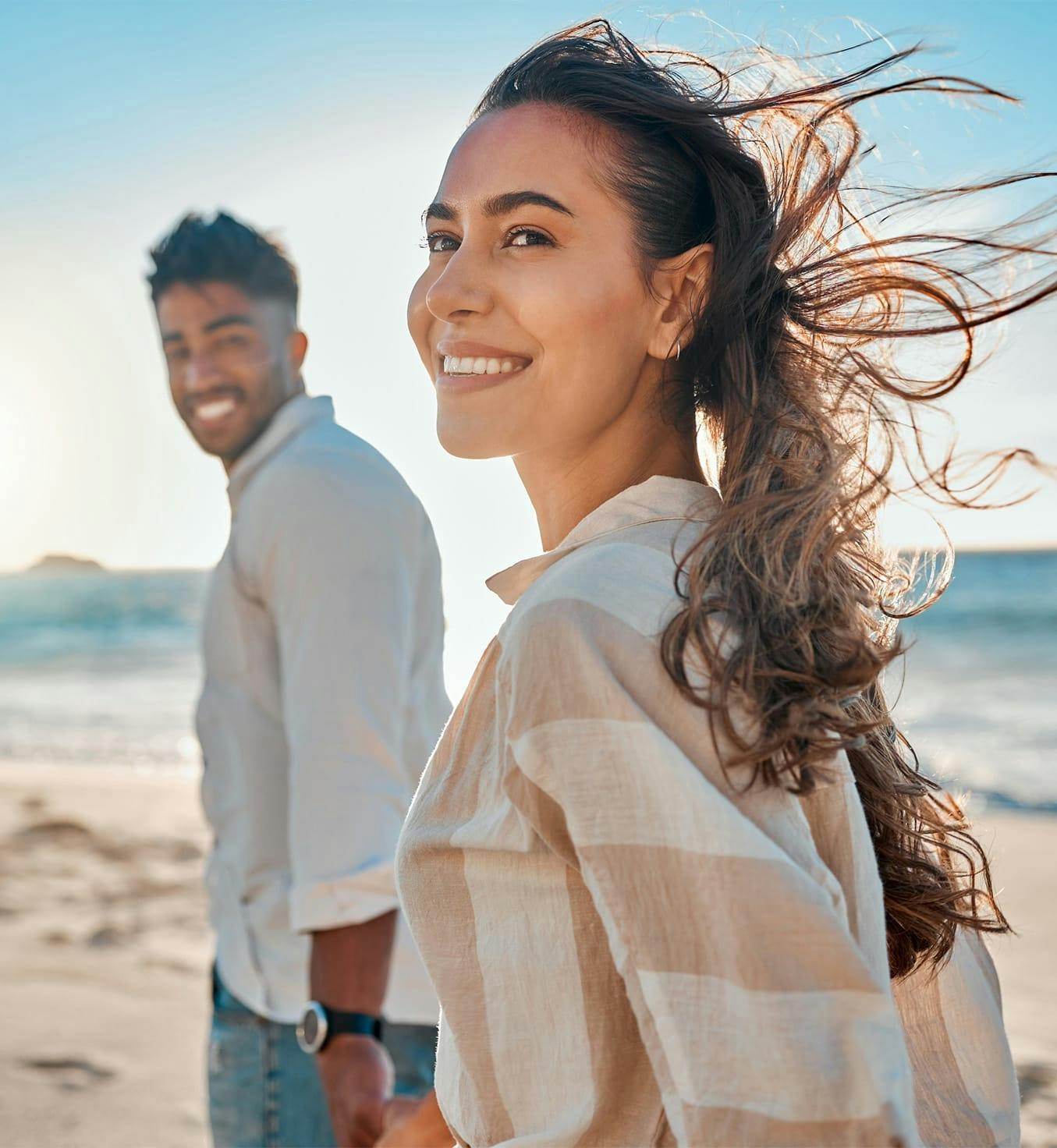 Woman and man walking on the beach