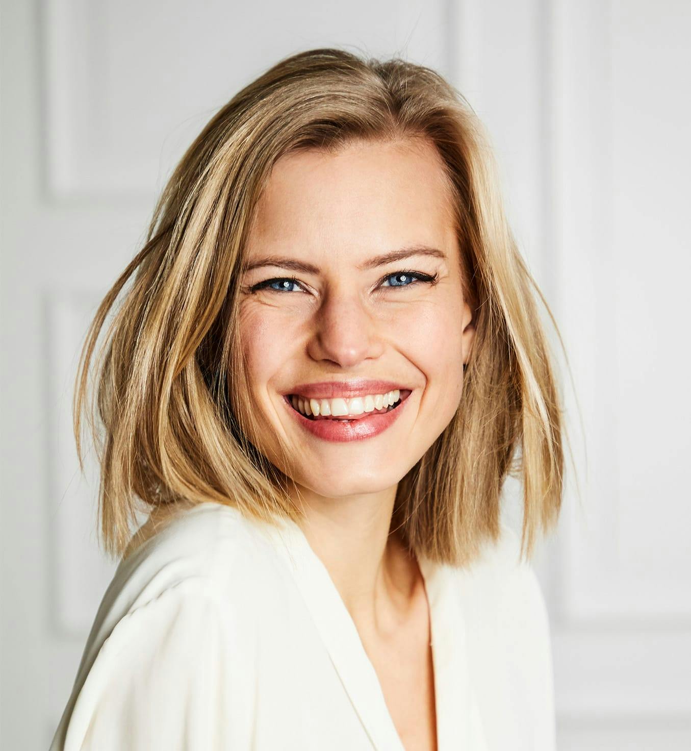 Woman with short blonde hair smiling