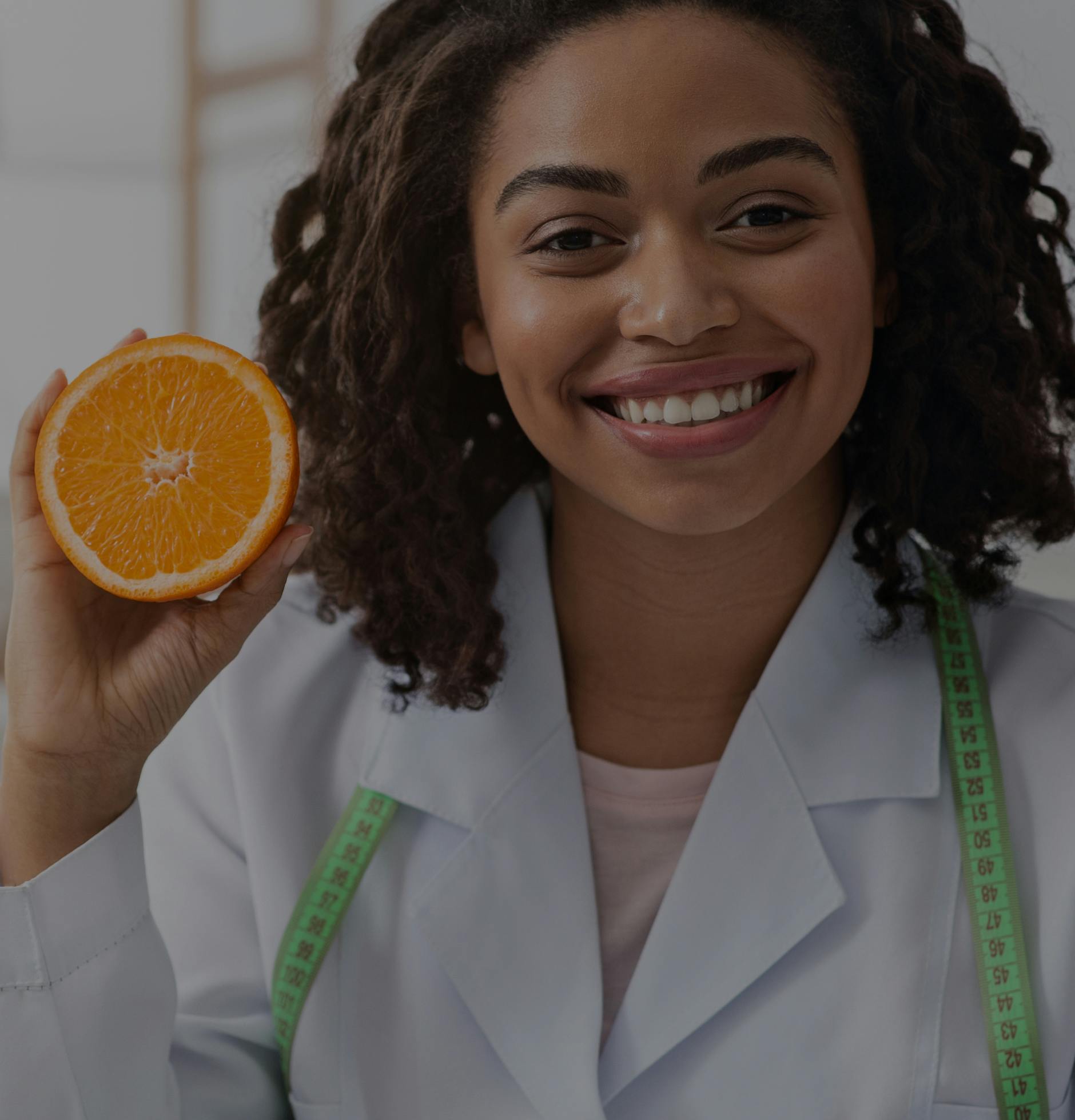 Woman standing on a scale and smiling