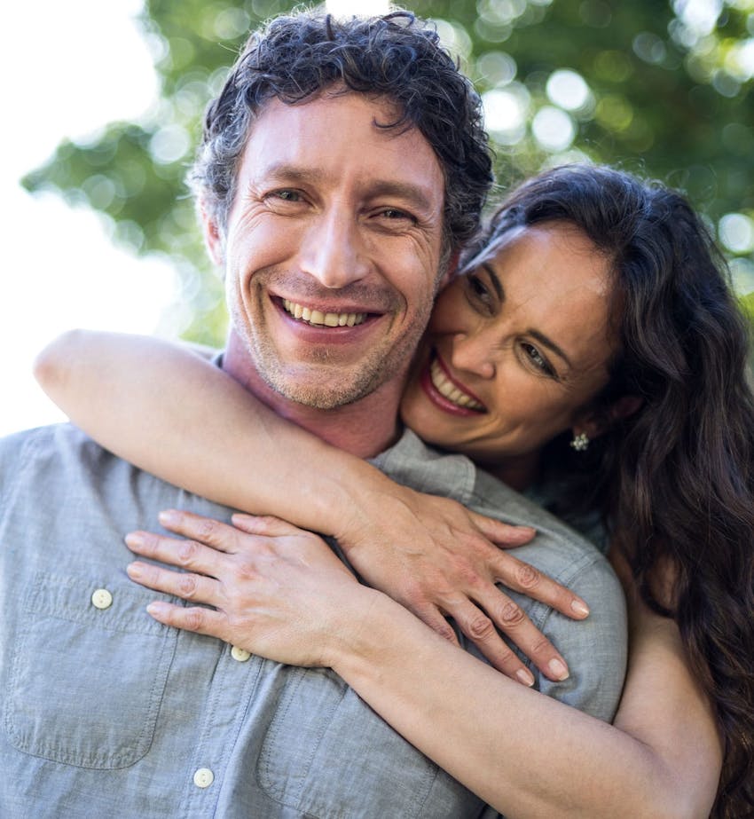 Happy couple hugging after hormone therapy at Serotonin Centers.